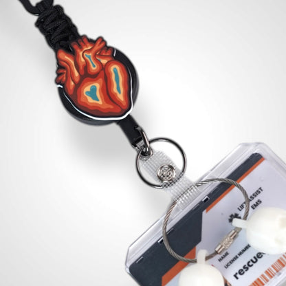 Trippy heart badge reel. On a carabiner with a steel retractable cable. Shown on a white background.
