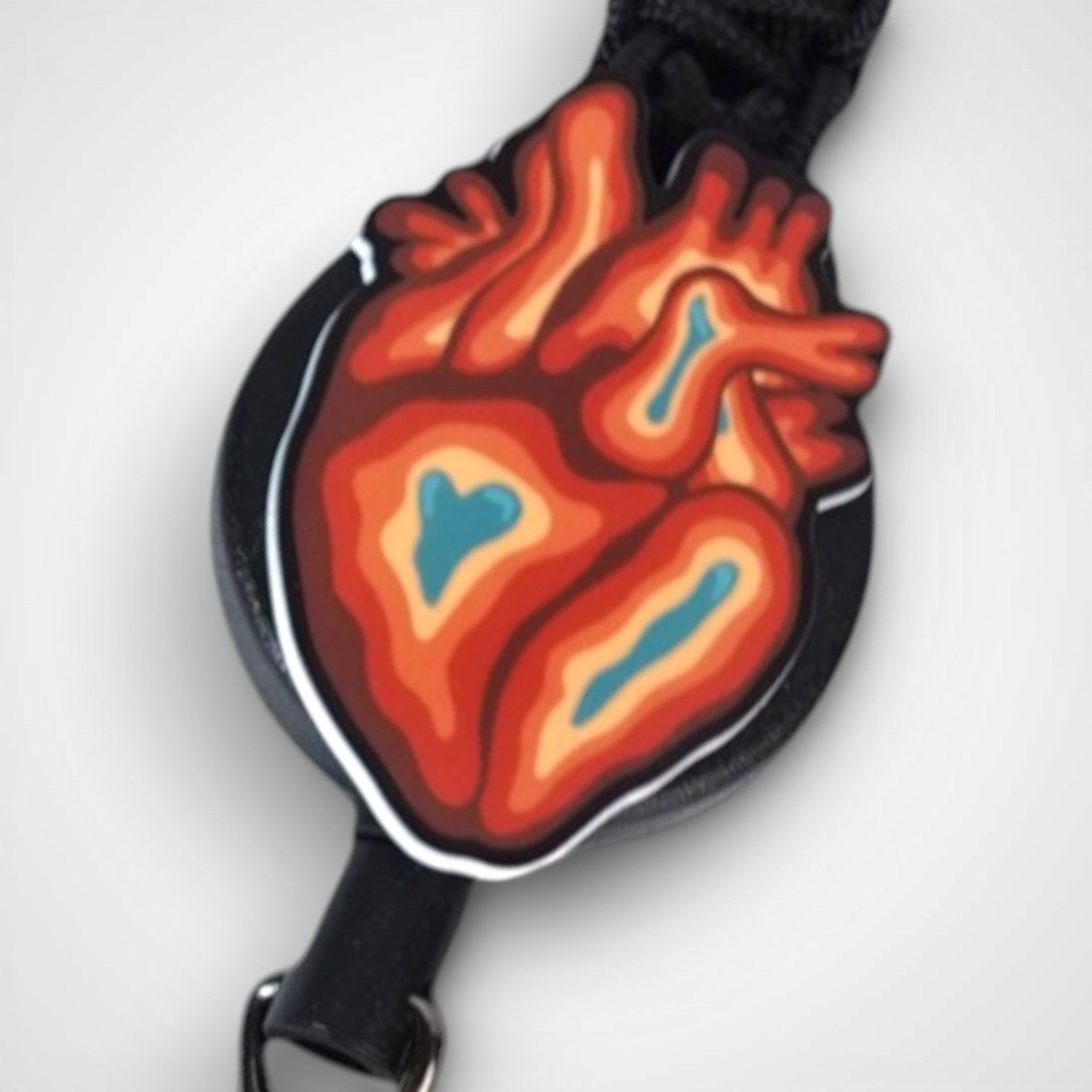 Trippy heart badge reel. On a carabiner with a steel retractable cable. Shown on a white background.
