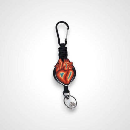 Trippy heart badge reel. On a carabiner with a steel retractable cable. Shown on a white background.