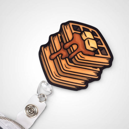 Waffle badge reel. On a swivel-alligator clip that rotates 360° with a nylon retractable string. Shown on a white background.