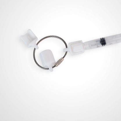 Three white polylactic acid created using additive manufacturing classic cap clips on steel cable keyring. Featured attached to a syringe. Shown on a white background.
