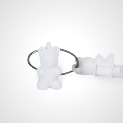 Two white polylactic acid created using additive manufacturing gummy bear cap clips on steel cable keyring. Featured attached to a syringe. Shown on a white background.