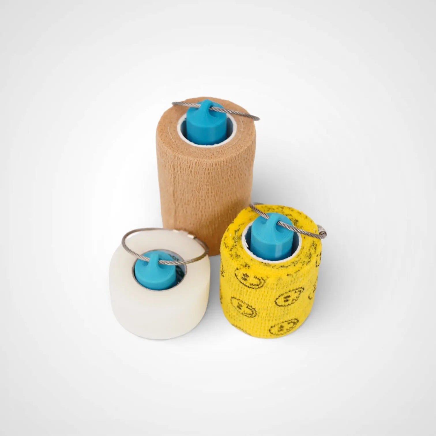 a compact utility keychain called a blue roll holder 3 inches tall, 2 inches tall, 1 inches tall to hold and tape transpore tape cohesive bandage coban and bangade rolls for EMS, paramedics, EMT's, nurses, flightmed, vetmed, and athletic trainers