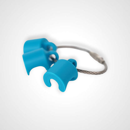 Blue polylactic acid created using additive manufacturing B-Braun cap clip on steel cable keyring. Shown on white background.