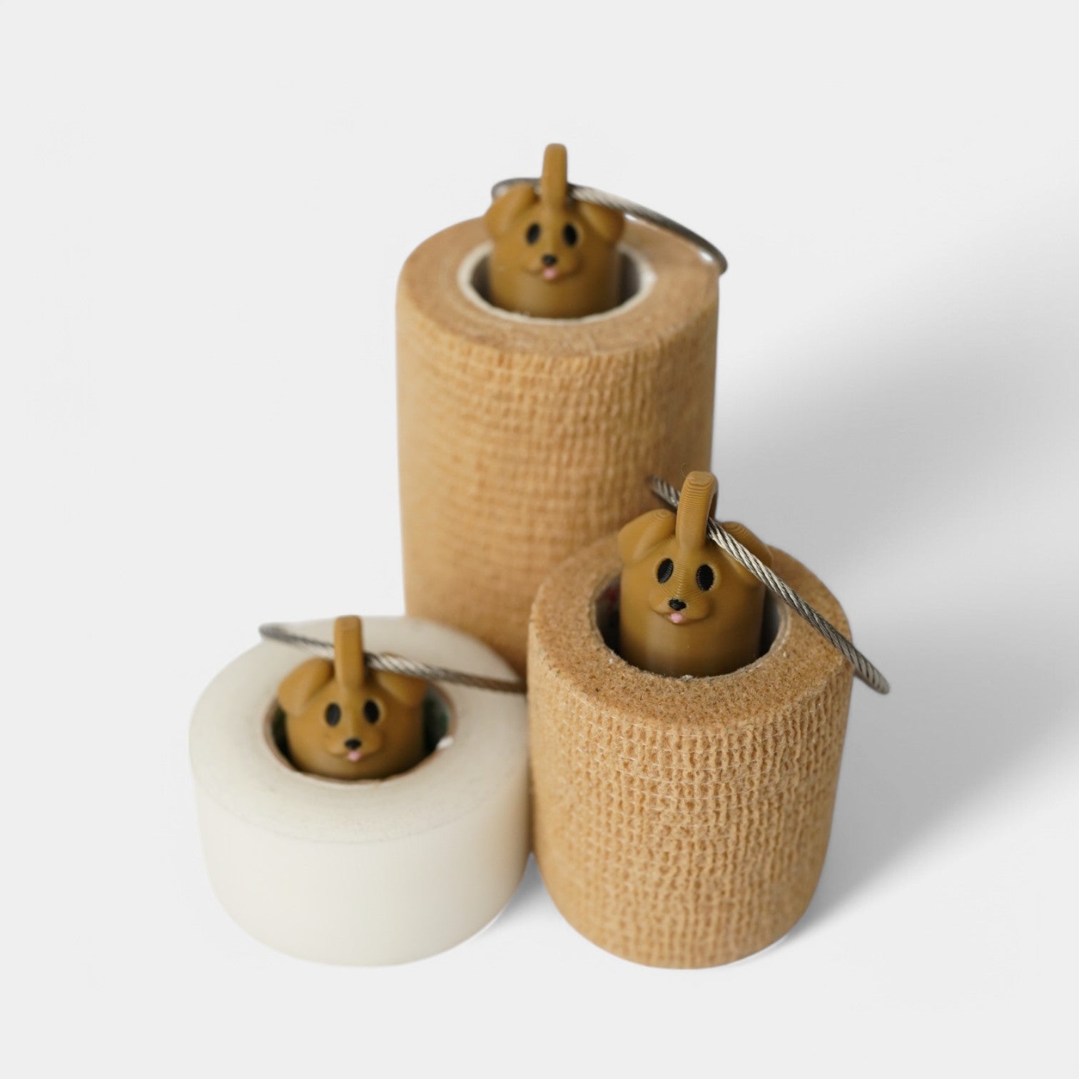 a compact brown dog roll holder to hold and tape and coban for EMS, paramedics, EMT's, nurses, flightmed, vetmed, and athletic trainers