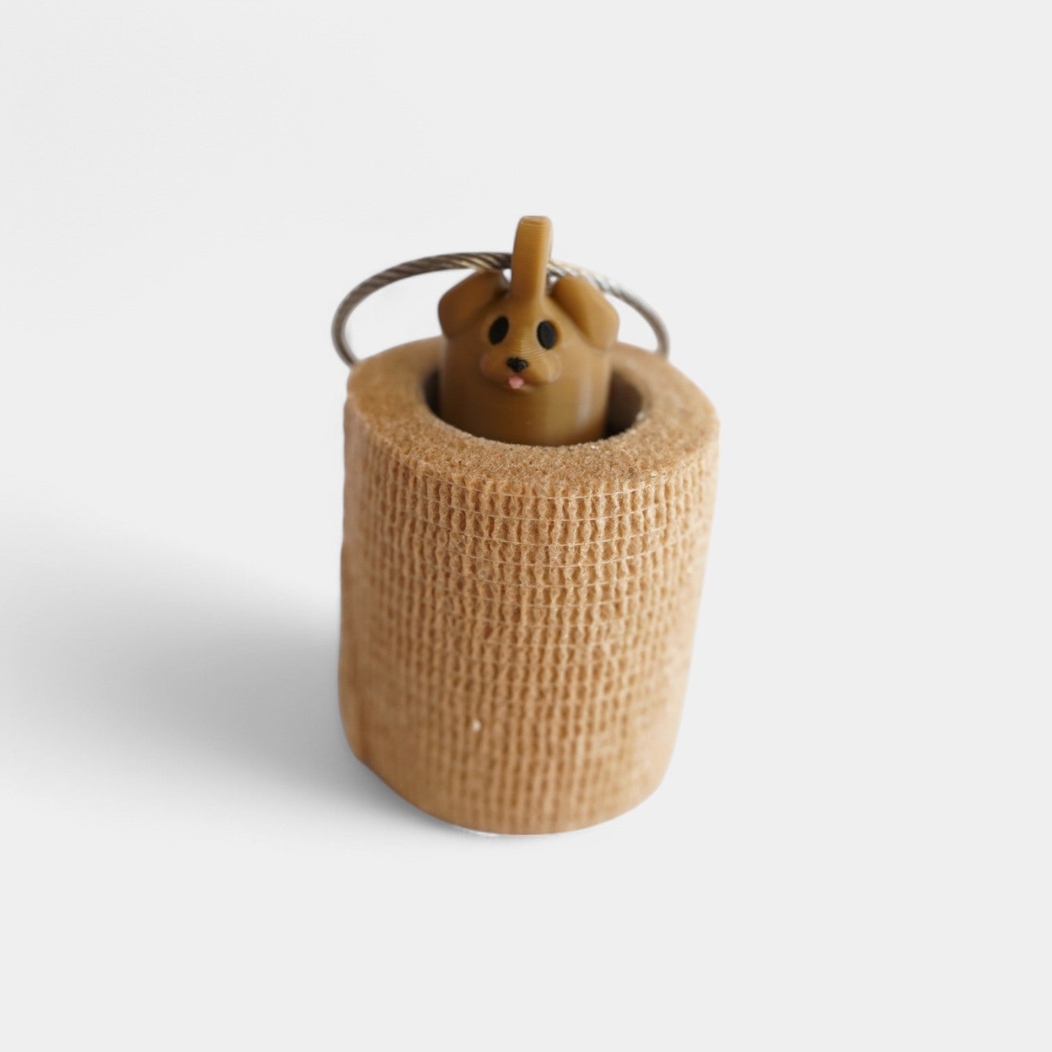 a compact brown dog roll holder 2 inches tall to hold and tape and coban for EMS, paramedics, EMT's, nurses, flightmed, vetmed, and athletic trainers