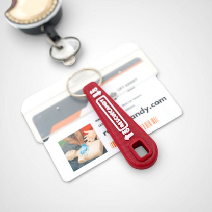 Mini red Oxygen Wrench. Made to fit CGA-870 valves. Shown attached to badge on white background.