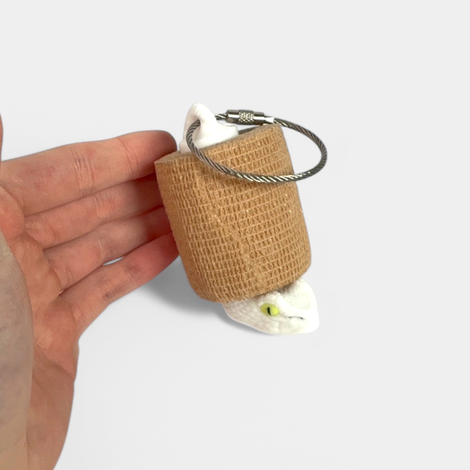 a compact white snake roll holder 2 inches tall to hold and tape and coban for EMS, paramedics, EMT's, nurses, flightmed, vetmed, and athletic trainers