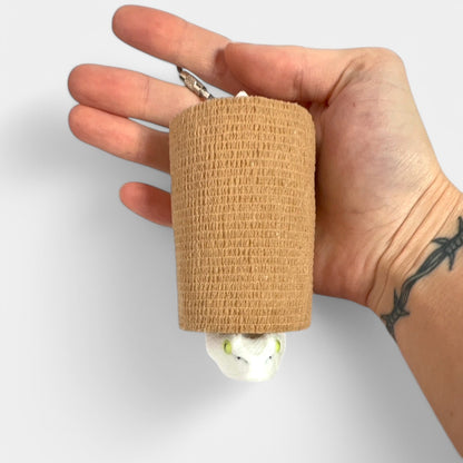 a compact white snake roll holder 3 inches tall to hold and tape and coban for EMS, paramedics, EMT's, nurses, flightmed, vetmed, and athletic trainers