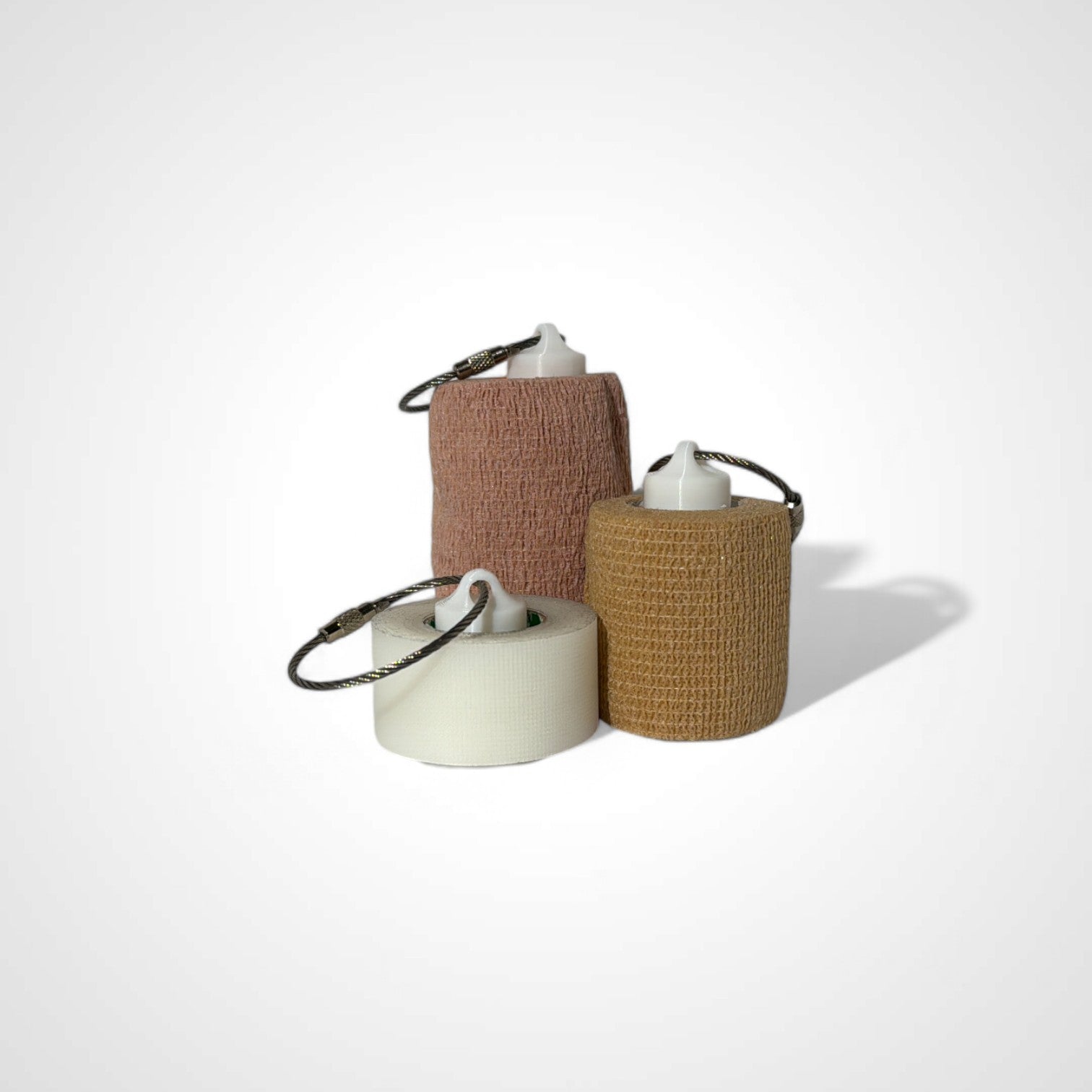a compact white roll holder to hold and tape and coban for EMS, paramedics, EMT's, nurses, flightmed, vetmed, and athletic trainers